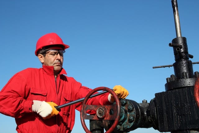 HPHT Well Cementing Challenges articel. Photo of a valve technician