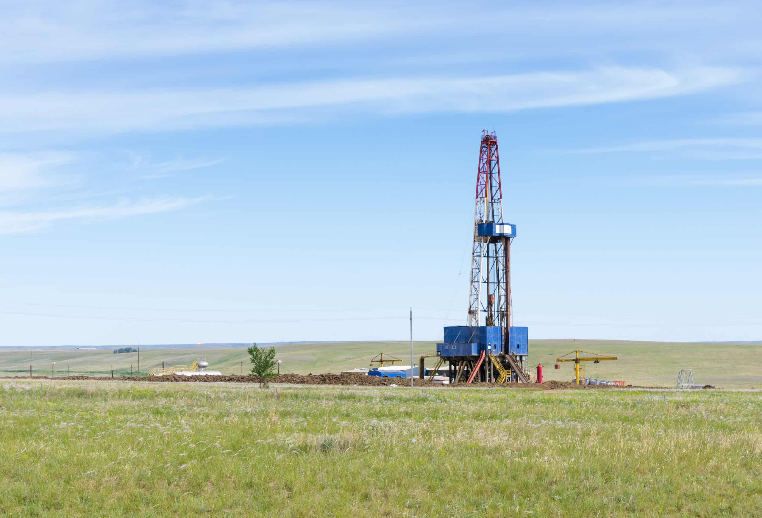 Drilling tower in the steppe. Steppe landscape with drilling rigs and equipment